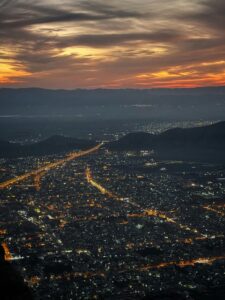 A stunning aerial view of Santiago, Chile, illuminated at sunset with a glowing sky.