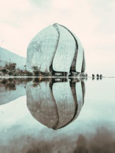Facade of contemporary spherical House of Worship composed of marble wings located in Santiago on waterfront