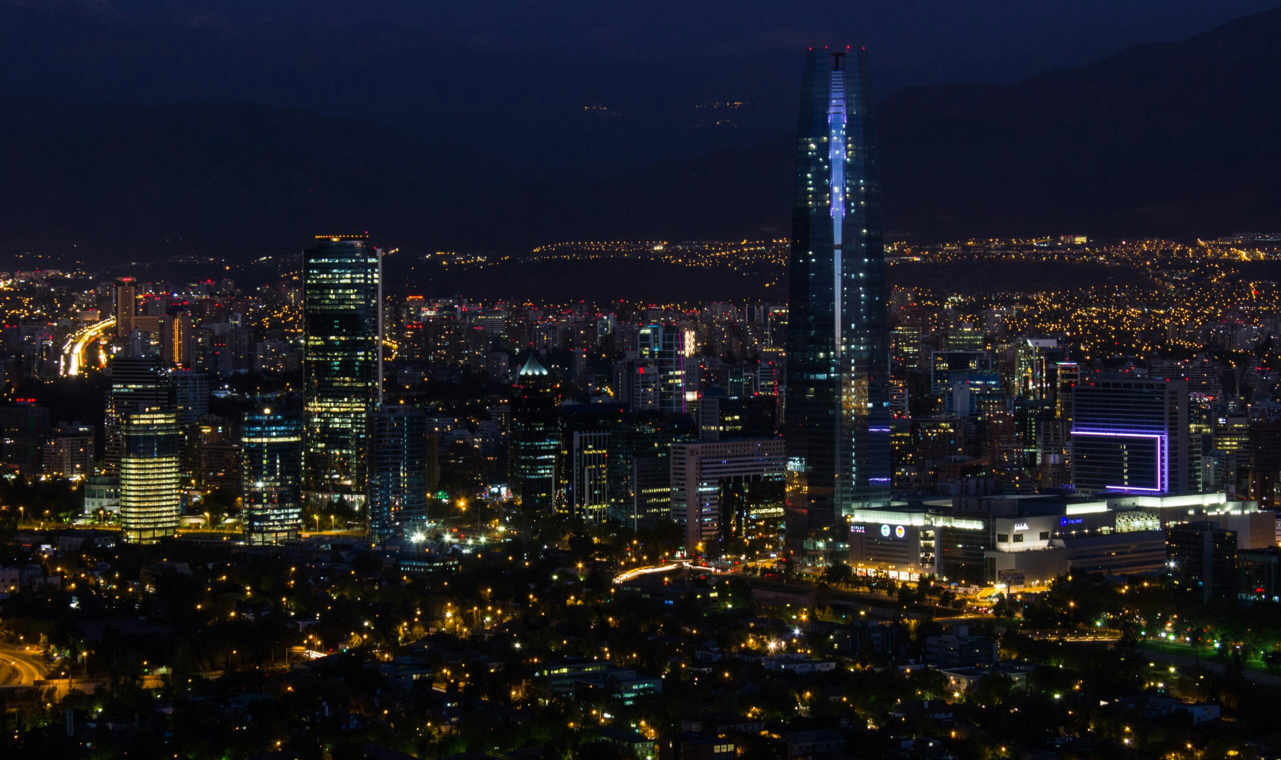 A captivating cityscape featuring glowing skyscrapers and bright city lights at night.